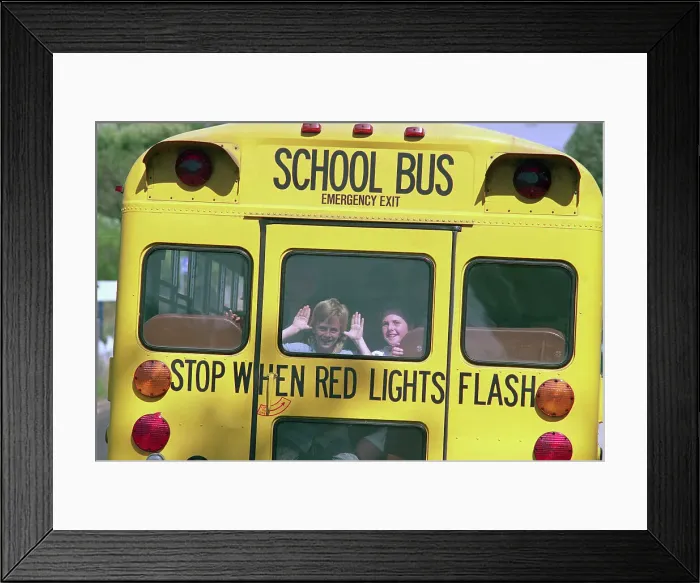 Framed Print : Children Waving from Back of School Bus Framed Print : Children Waving from Back of School Bus