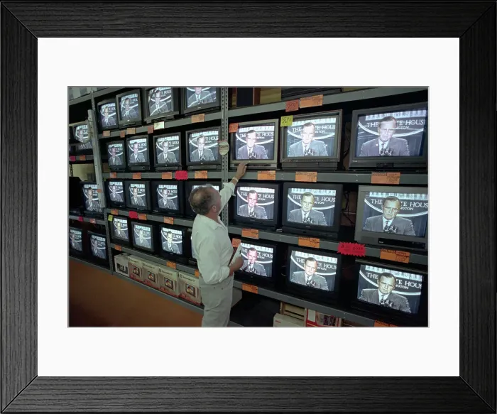 Framed Print : Customer Watching George Bush on Television Framed Print : Customer Watching George Bush on Television