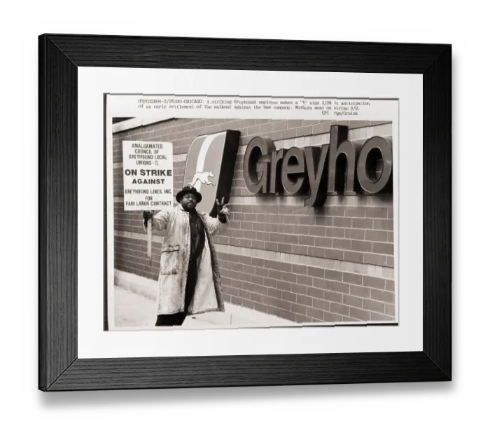 Framed Print : Striker Stands Beside Greyhound Sign
