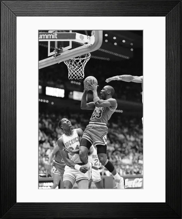 Framed Print : Michael Jordan Jumping Over Akeem Olajuwan to Score Framed Print : Michael Jordan Jumping Over Akeem Olajuwan to Score