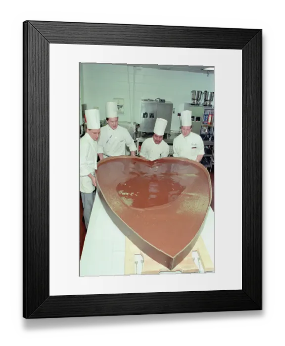 Framed Print : Chefs Pouring Chocolate Into Large Heart Mold Framed Print : Chefs Pouring Chocolate Into Large Heart Mold