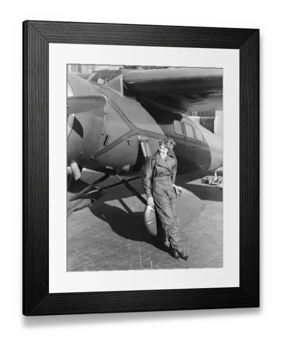 Framed Print : Amelia Earhart Shown With Her Airplane