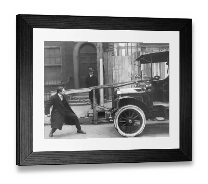 Framed Print : Boy Pulling Car with His Teeth Framed Print : Boy Pulling Car with His Teeth