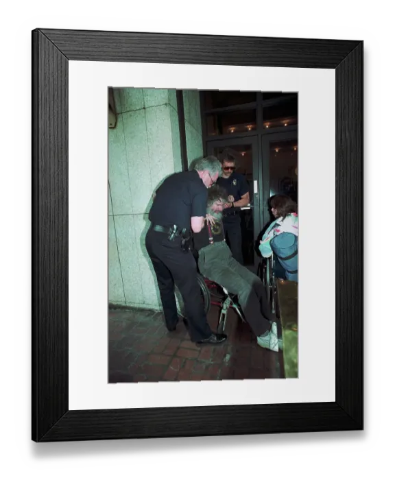 Framed Print : Wheelchair Bound Protester Blocking Building Entrance