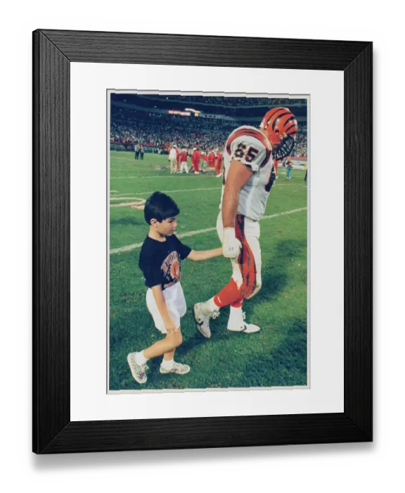 Framed Print : Max Montoya Strolling with His Son Across Football Turf Framed Print : Max Montoya Strolling with His Son Across Football Turf