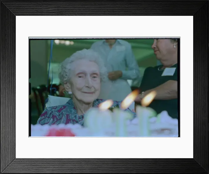 Framed Print : Old Woman Observing Birthday Candles Framed Print : Old Woman Observing Birthday Candles