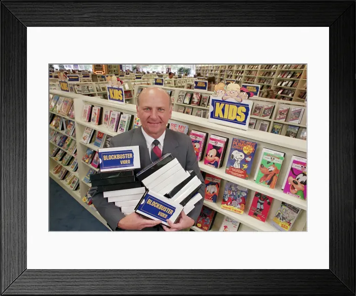 Framed Print : Man with Armload of Videos Framed Print : Man with Armload of Videos