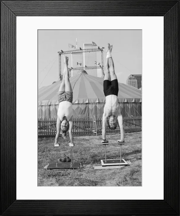Framed Print : Man and Woman Practice Handstands