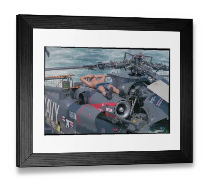 Framed Print : Machinist Relaxing Atop Helicopter