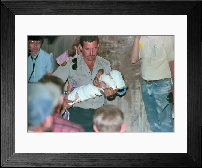 Framed Print : Rescuer Running with Baby Jessica Framed Print : Rescuer Running with Baby Jessica