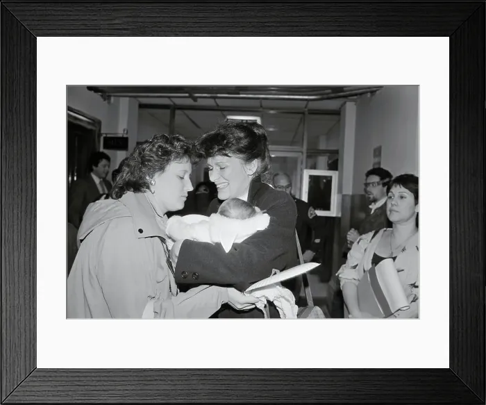 Framed Print : Woman Receiving Baby Framed Print : Woman Receiving Baby