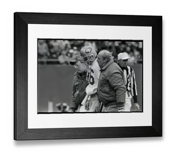 Framed Print : Joe Montana Being Helped from Field Framed Print : Joe Montana Being Helped from Field