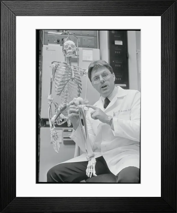 Framed Print : Doctor Pointing to Area on Skeleton Framed Print : Doctor Pointing to Area on Skeleton