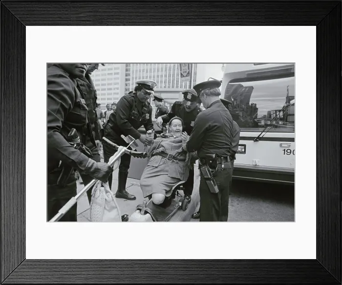 Framed Print : Policemen Arresting Disabled Woman Framed Print : Policemen Arresting Disabled Woman