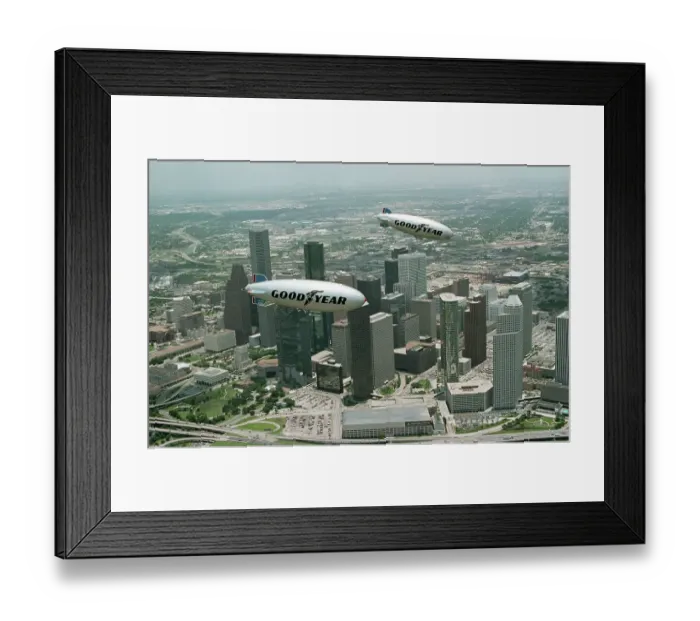 Framed Print : Old and New Goodyear Blimps Fly Above Houston