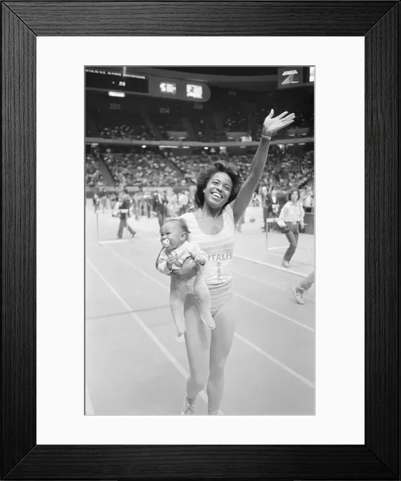 Framed Print : Evelyn Ashford Holds Daughter On Track Framed Print : Evelyn Ashford Holds Daughter On Track