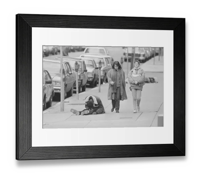 Framed Print : Two Women Passing by a Homeless Man Framed Print : Two Women Passing by a Homeless Man