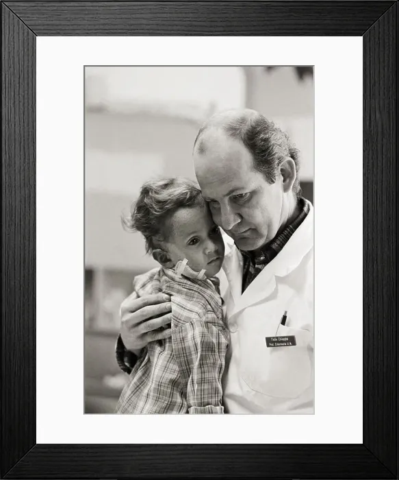 Framed Print : Dr Chiappe Holds 2 Yr.Old Volcano Victim