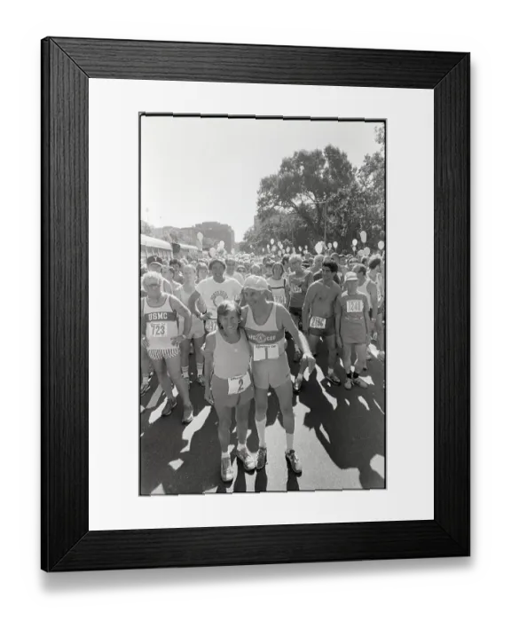 Framed Print : Elderly Marathon Runners Hug & Pose Framed Print : Elderly Marathon Runners Hug & Pose