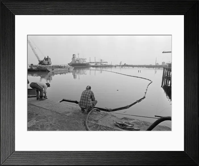 Framed Print : Worker Pumping Oil From River W / Hose Framed Print : Worker Pumping Oil From River W / Hose