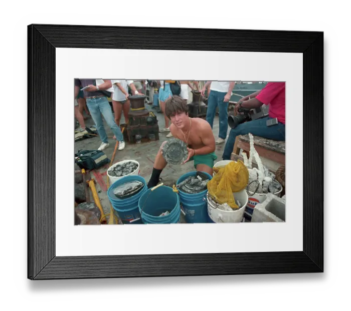 Framed Print : Man Holding up Plate from Ship Wreck Framed Print : Man Holding up Plate from Ship Wreck
