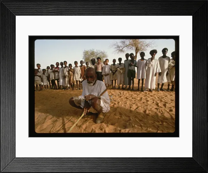 Framed Print : Man Squatting in Front of Children
