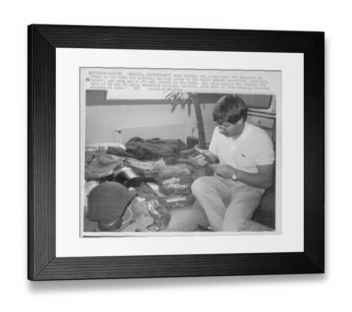 Framed Print : Swiss Soldier Looking over His Weapons at Home Framed Print : Swiss Soldier Looking over His Weapons at Home