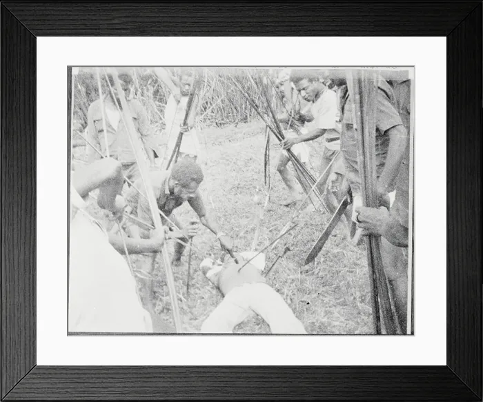 Framed Print : New Guinea Rebels with Weapons Surrounding Slain Victim Framed Print : New Guinea Rebels with Weapons Surrounding Slain Victim