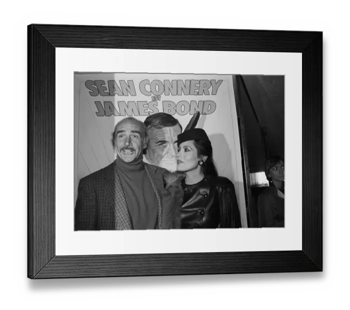 Framed Print : Sean Connery and Barbara Carrera in Front of Poster Framed Print : Sean Connery and Barbara Carrera in Front of Poster