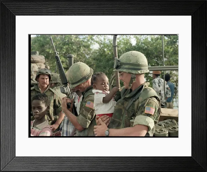 Framed Print : Soldiers Play with Baby While Holding Guns Framed Print : Soldiers Play with Baby While Holding Guns