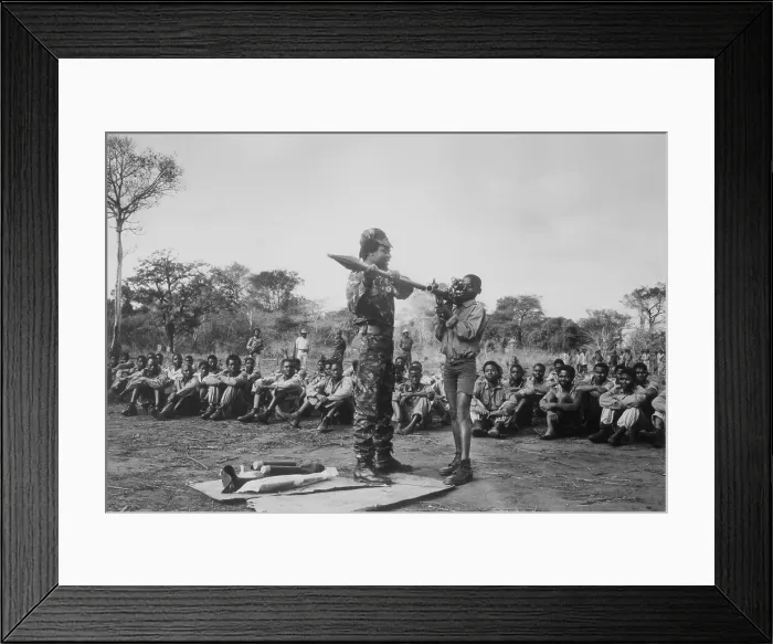 Framed Print : Mozambican Soldier Instructing Youngsters on Rocket Launching Framed Print : Mozambican Soldier Instructing Youngsters on Rocket Launching