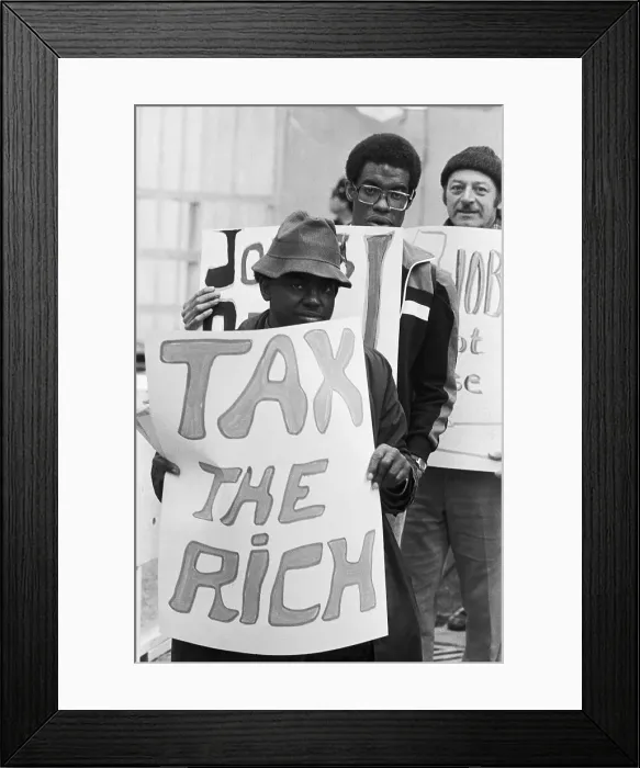 Framed Print : Man Holds Tax The Rich Sign In Protest Framed Print : Man Holds Tax The Rich Sign In Protest