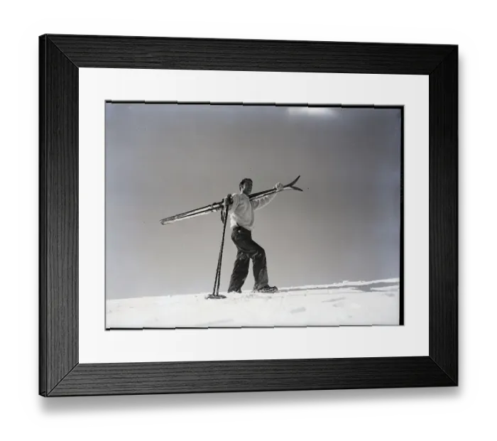 Framed Print : Man Walks Through Snow with Skis on Shoulder Framed Print : Man Walks Through Snow with Skis on Shoulder