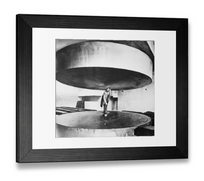 Framed Print : Man Standing Between Two Huge Discs Framed Print : Man Standing Between Two Huge Discs