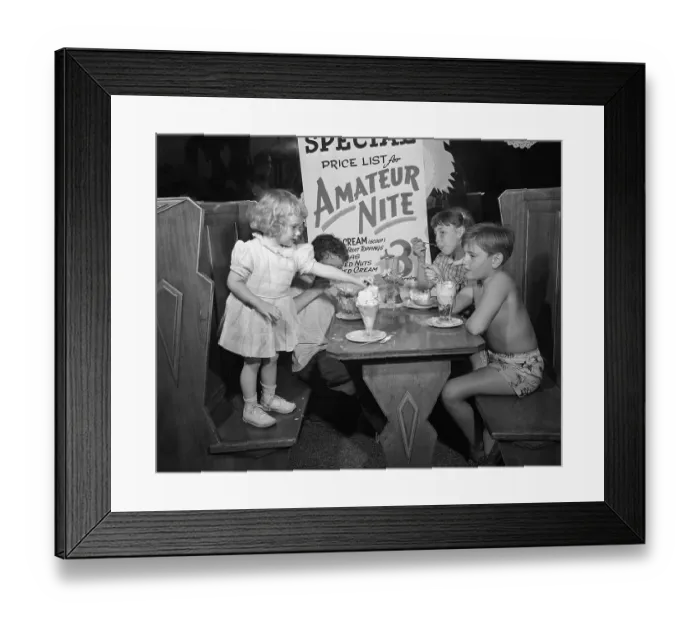Framed Print : Toddler (2-3 years) and children (10-12 years) eating icecream at booth table. Los Angeles, California, USA. July 02, 1948 Framed Print : Toddler (2-3 years) and children (10-12 years) eating icecream at booth table. Los Angeles, California, USA. July 02, 1948
