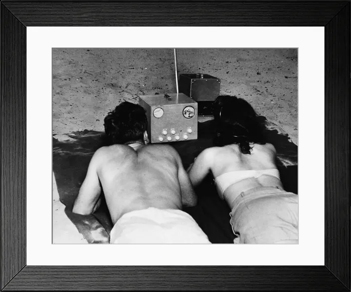 Framed Print : Couple Watches Portable Tv On Beach