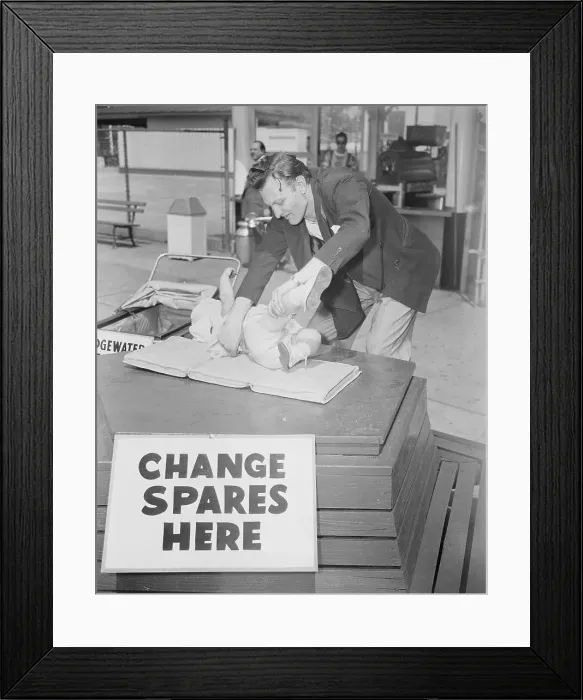 Framed Print : Parent Changing Diaper of Baby Framed Print : Parent Changing Diaper of Baby