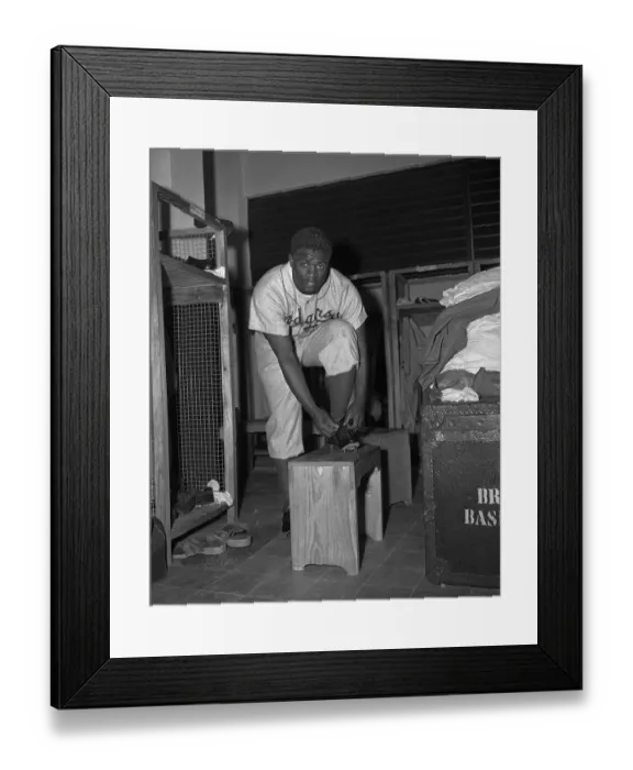 Framed Print : Jackie Robinson Putting on Uniform
