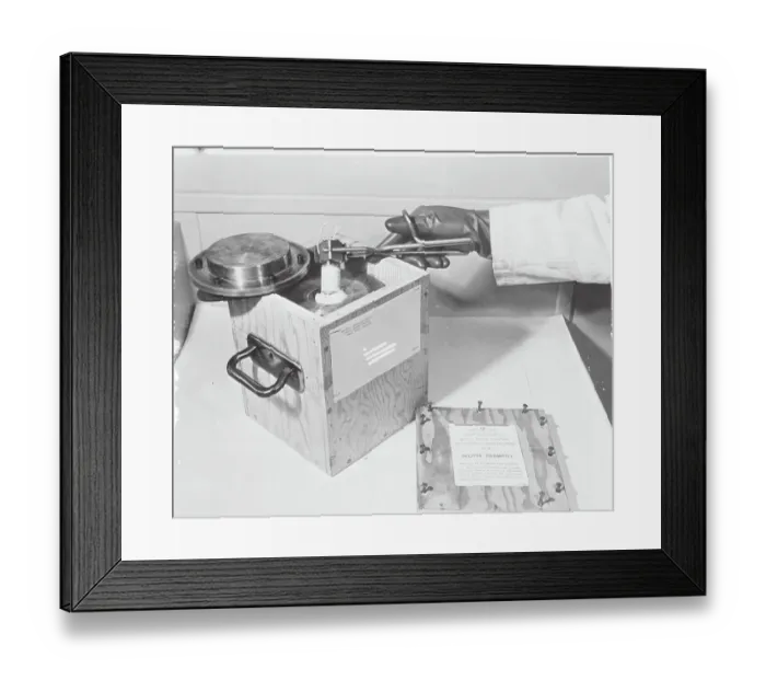 Framed Print : Hand Placing Isotope in Box Framed Print : Hand Placing Isotope in Box