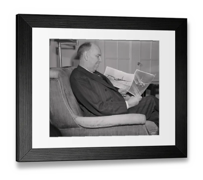 Framed Print : Owen Brewster Looking at Photos of Howard Hughes Plane Framed Print : Owen Brewster Looking at Photos of Howard Hughes Plane