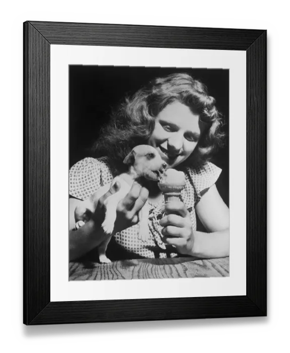 Framed Print : Girl Feeding Ice Cream Cone to Puppy Framed Print : Girl Feeding Ice Cream Cone to Puppy