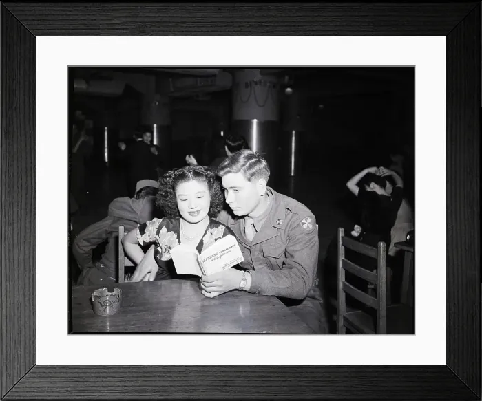 Framed Print : U.S. Private and Japanese Girl Look at Book
