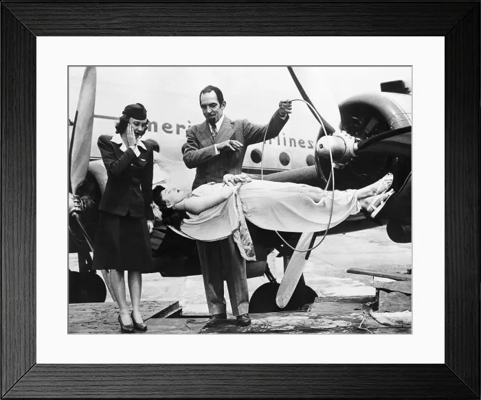 Framed Print : Stewardess Watching Magician Levitate Woman