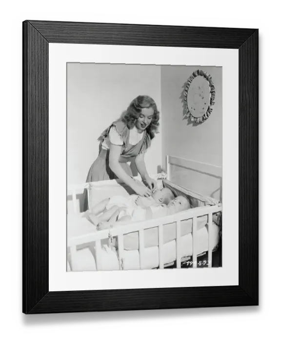 Framed Print : Marilyn Monroe Standing over Babies in Crib Framed Print : Marilyn Monroe Standing over Babies in Crib