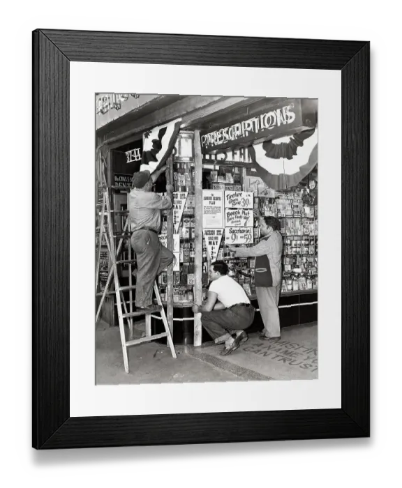 Framed Print : Store Owner Preparing Window for a Sale