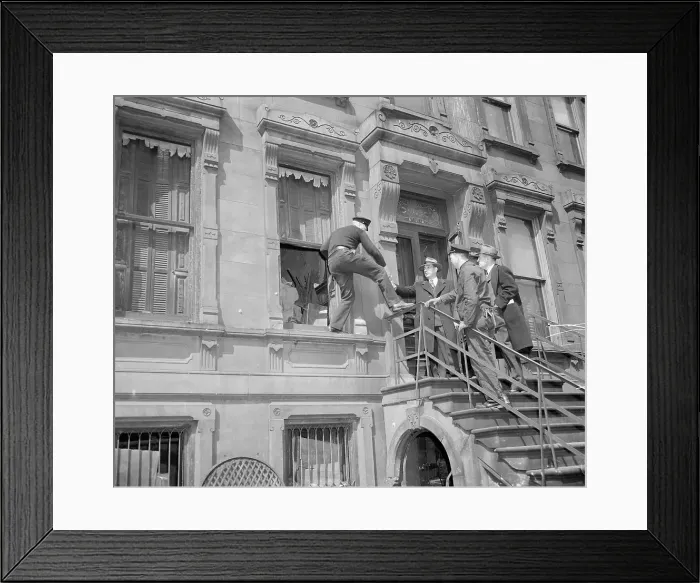 Framed Print : Policeman Climbing From the Front Window of a House Framed Print : Policeman Climbing From the Front Window of a House