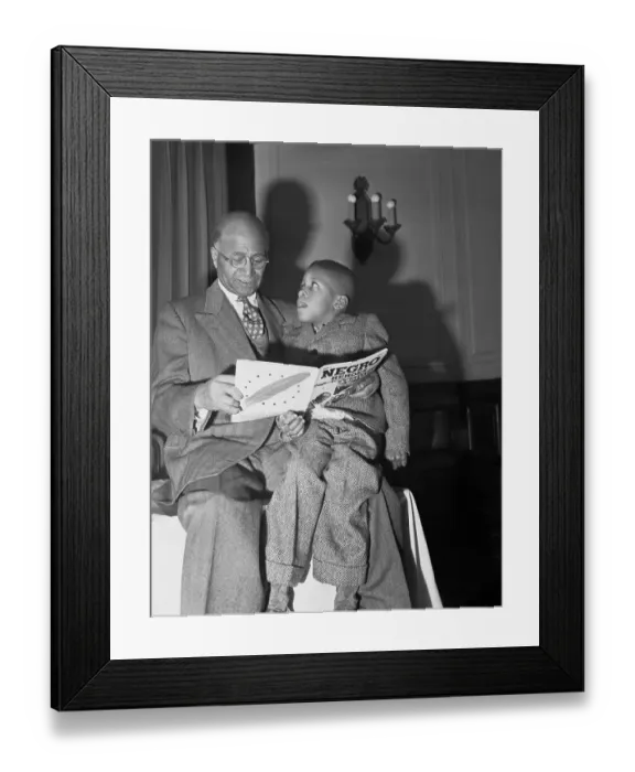 Framed Print : Matt Henson Reading Book to Child Framed Print : Matt Henson Reading Book to Child