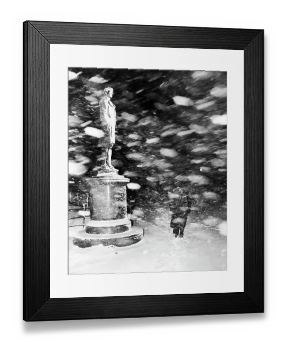 Framed Print : Pedestrian Passing Statue in Snow Storm
