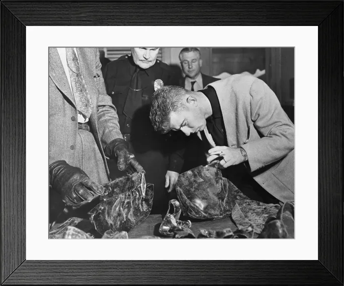 Framed Print : Man Inspecting Purses at Police Station Framed Print : Man Inspecting Purses at Police Station
