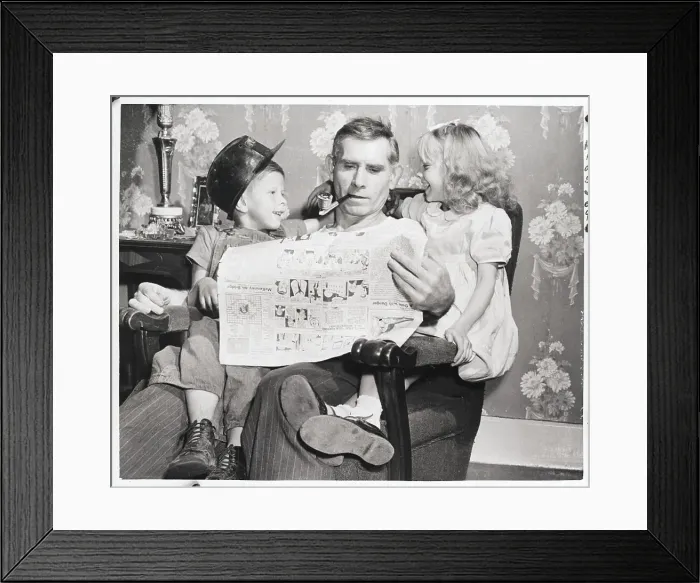 Framed Print : Man Reading Newspaper With Grandchildren Framed Print : Man Reading Newspaper With Grandchildren